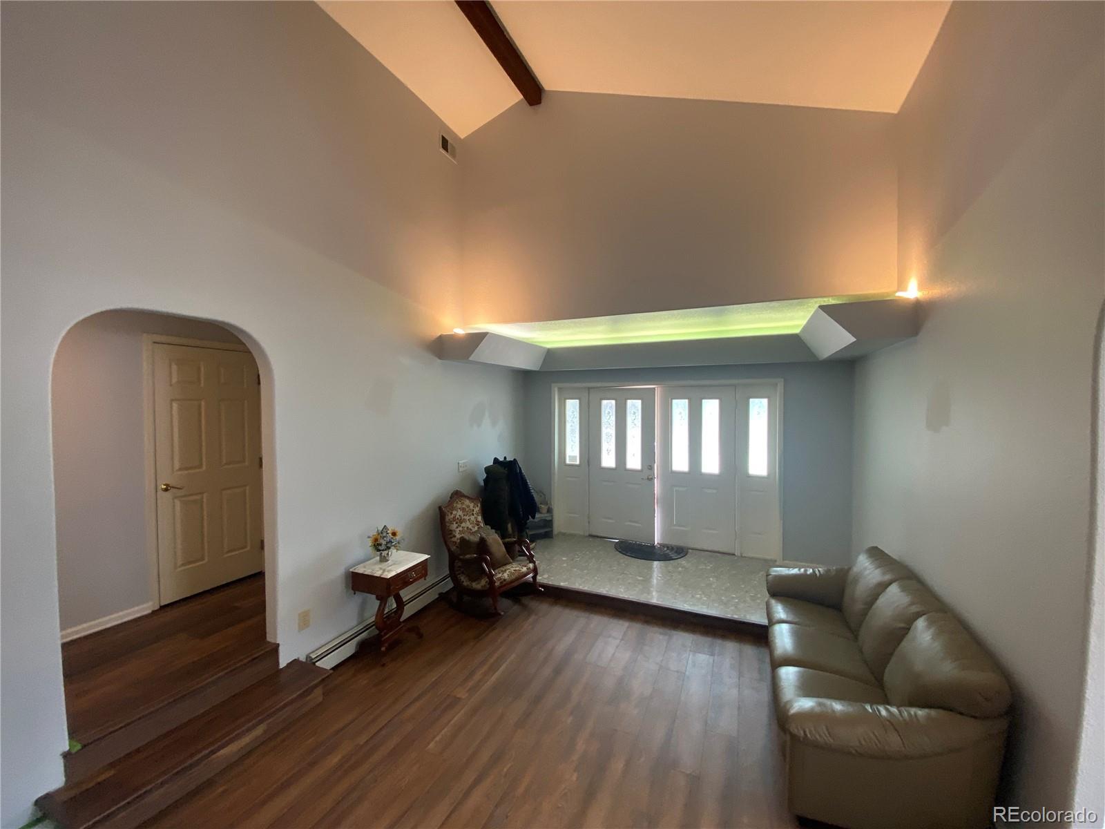 7079 Estes Drive Arvada, CO 80004 - Photo 12 of 50 a living room with furniture and a wooden floor