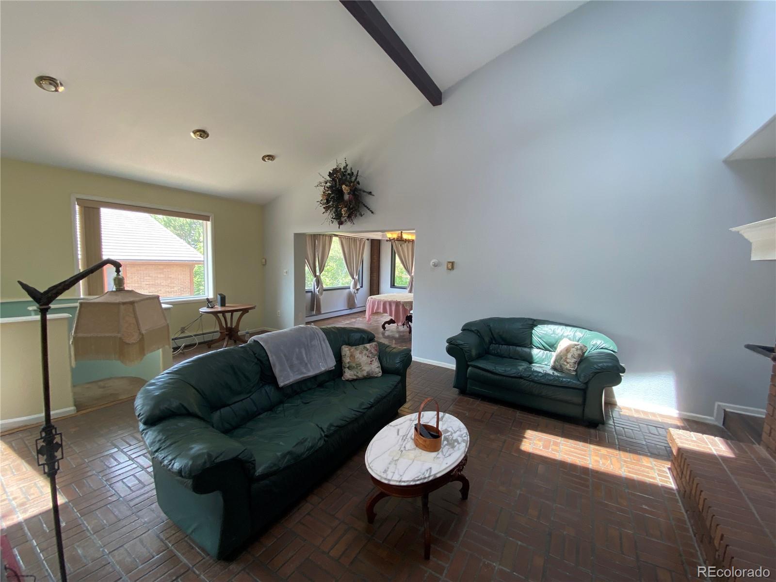 7079 Estes Drive Arvada, CO 80004 - Photo 13 of 50 a living room with furniture and a wooden floor
