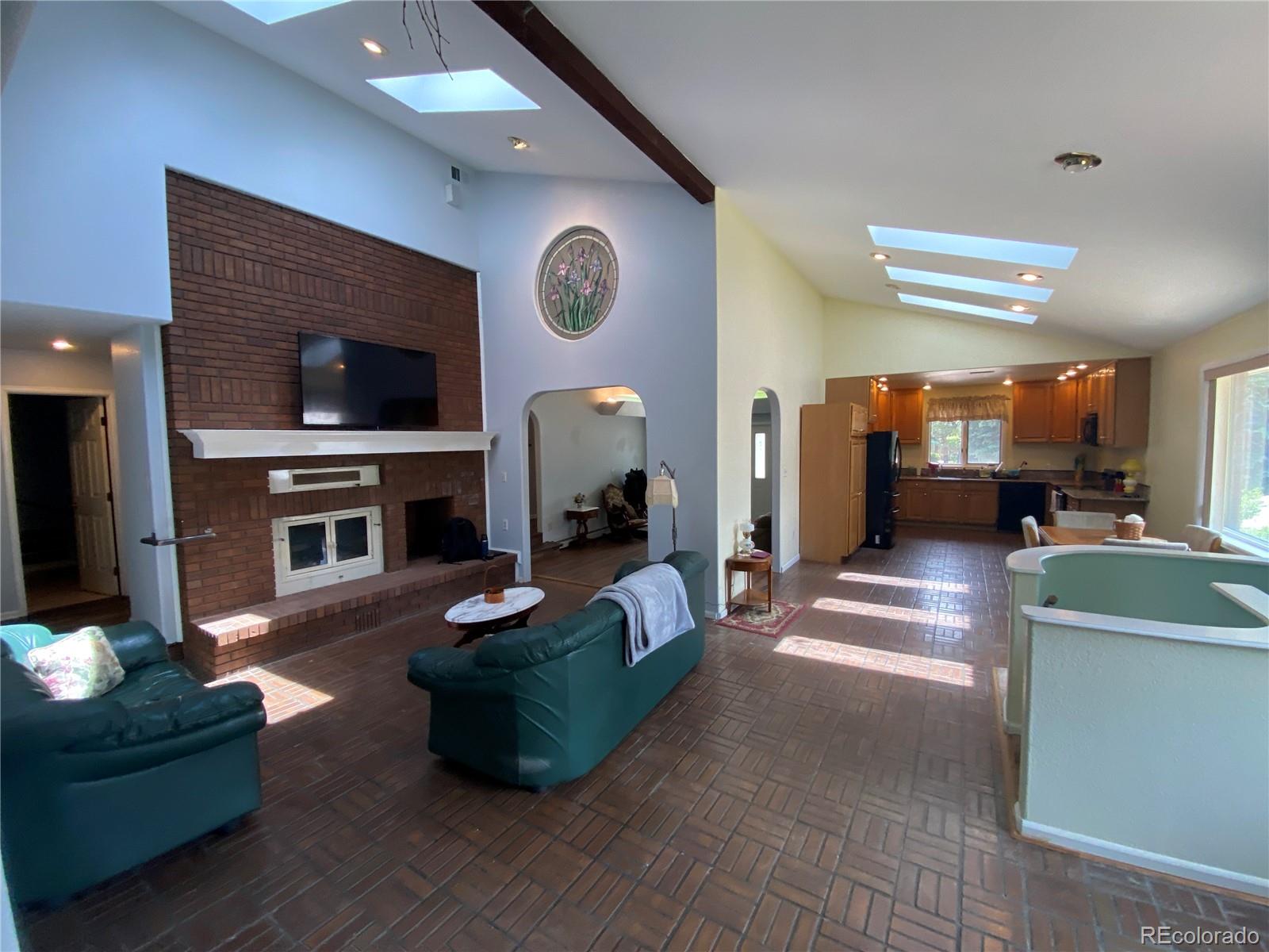 7079 Estes Drive Arvada, CO 80004 - Photo 14 of 50 a living room with furniture and a flat screen tv