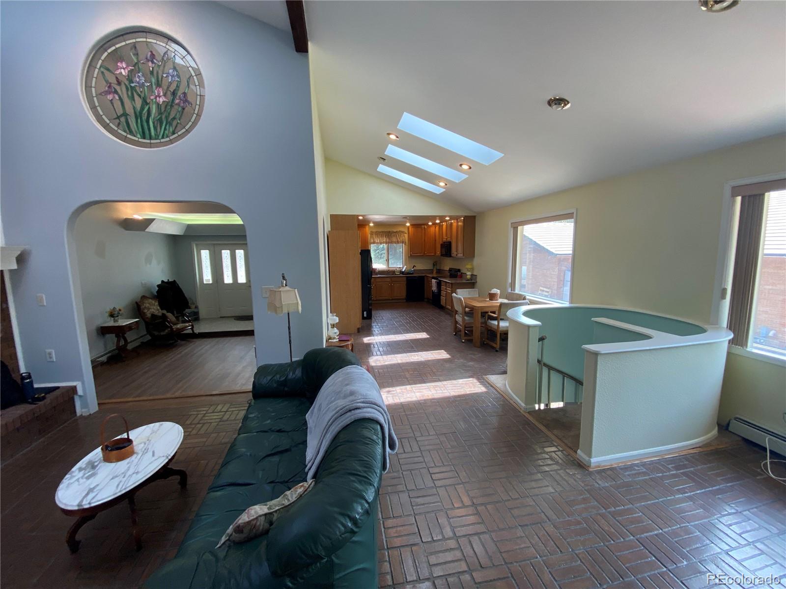 7079 Estes Drive Arvada, CO 80004 - Photo 15 of 50 a living room with furniture a rug and a large window