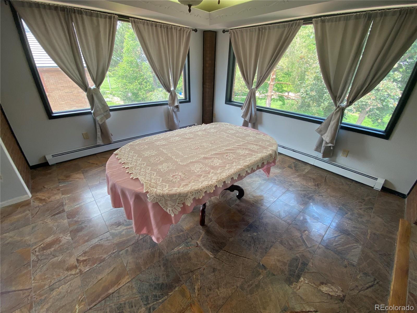 7079 Estes Drive Arvada, CO 80004 - Photo 18 of 50 a room with a window and a table