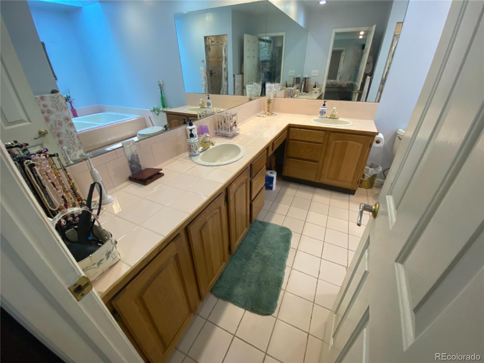 7079 Estes Drive Arvada, CO 80004 - Photo 24 of 50 a bathroom with sink shower and mirror