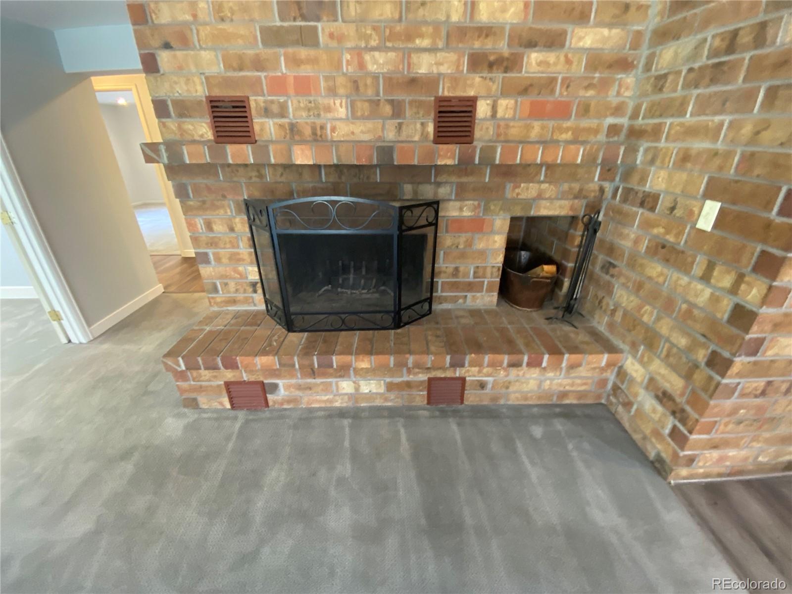 7079 Estes Drive Arvada, CO 80004 - Photo 37 of 50 a room with a fireplace