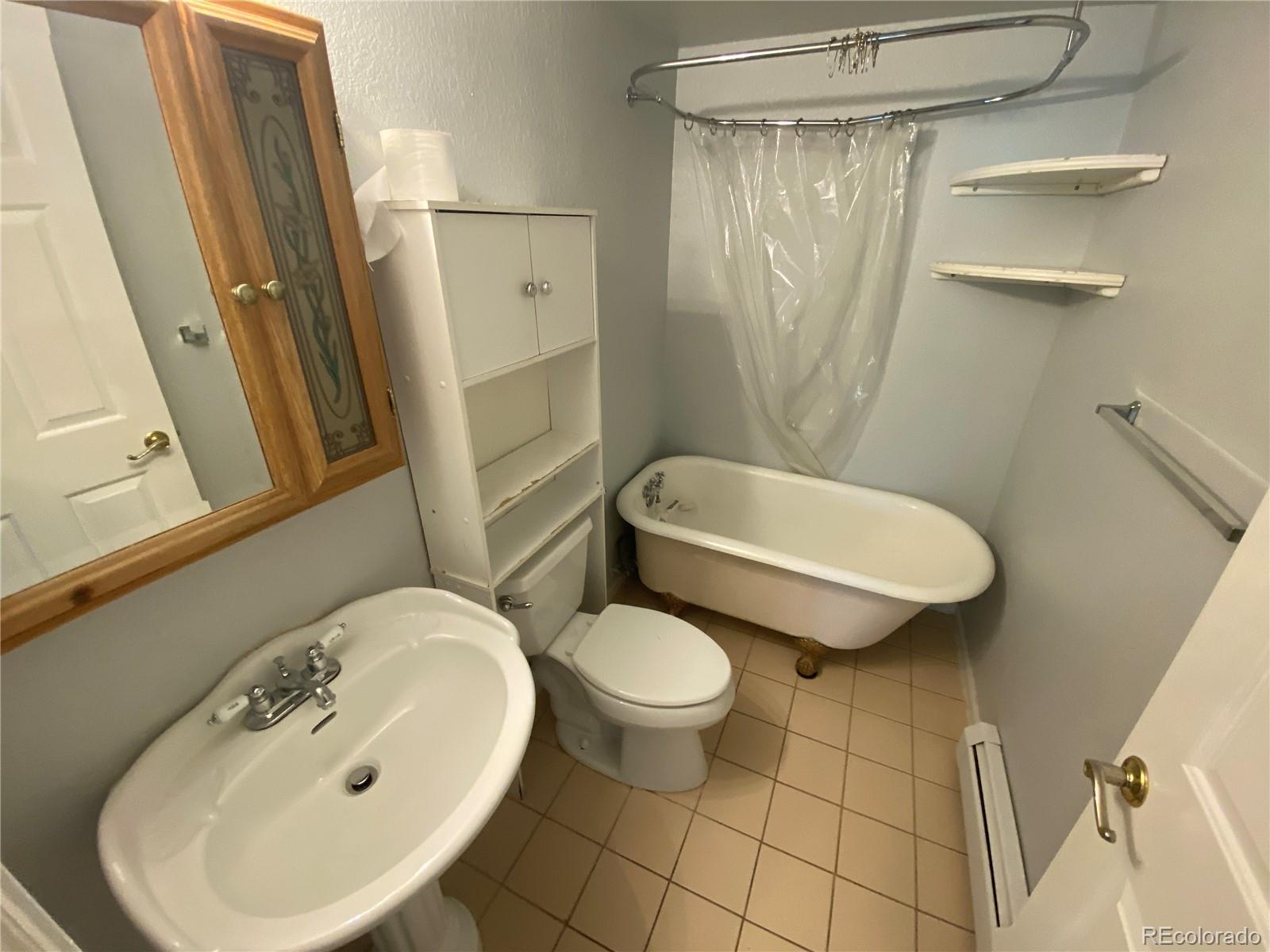 7079 Estes Drive Arvada, CO 80004 - Photo 43 of 50 a bathroom with a sink a toilet and shower