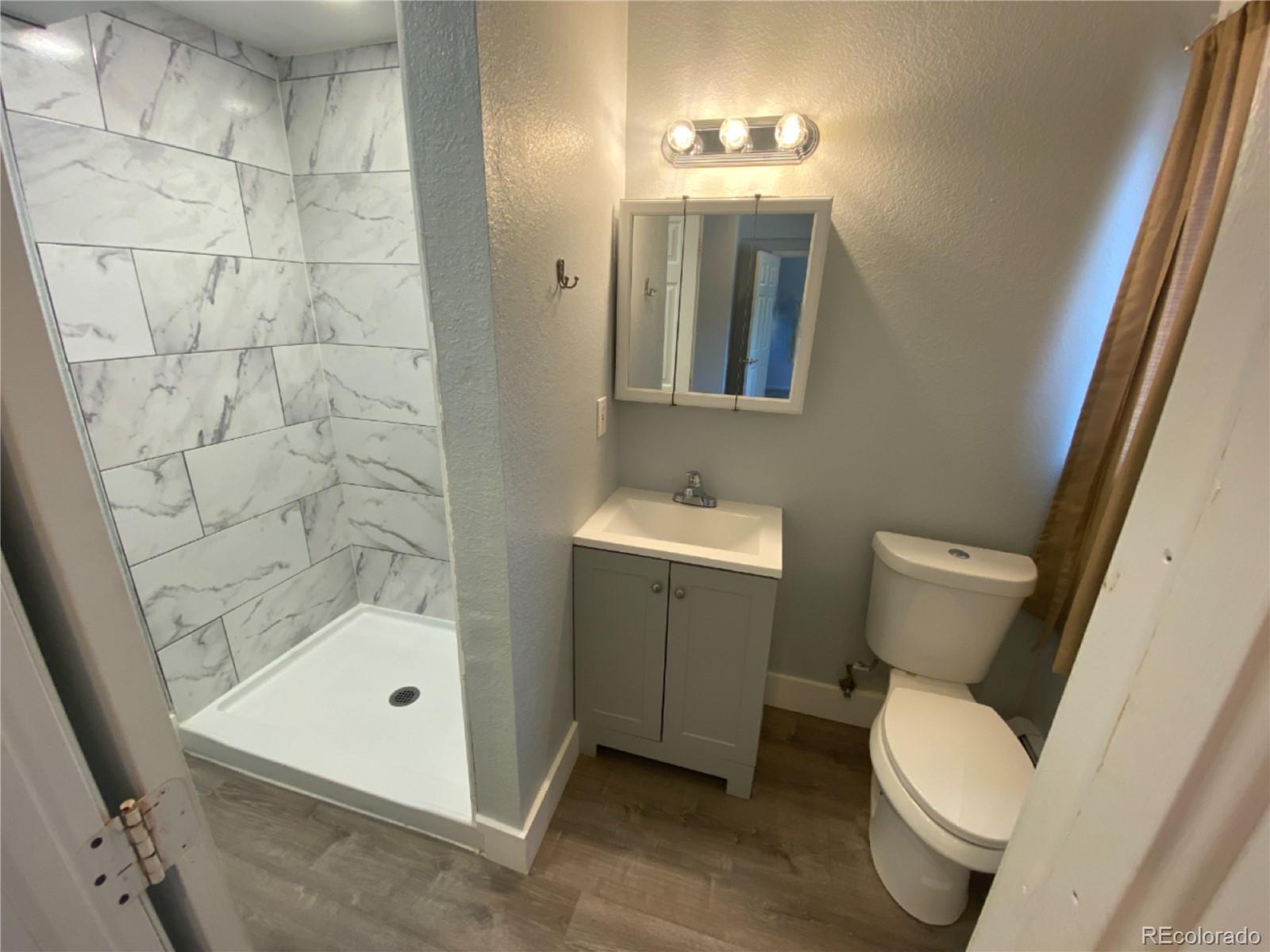 7079 Estes Drive Arvada, CO 80004 - Photo 46 of 50 a bathroom with a sink and a mirror