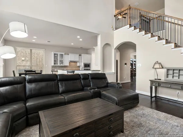 a living room with furniture and a dining table
