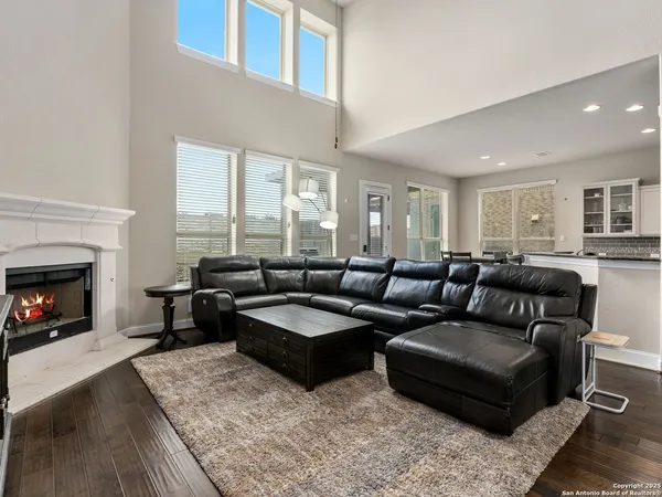a living room with furniture window and a fireplace