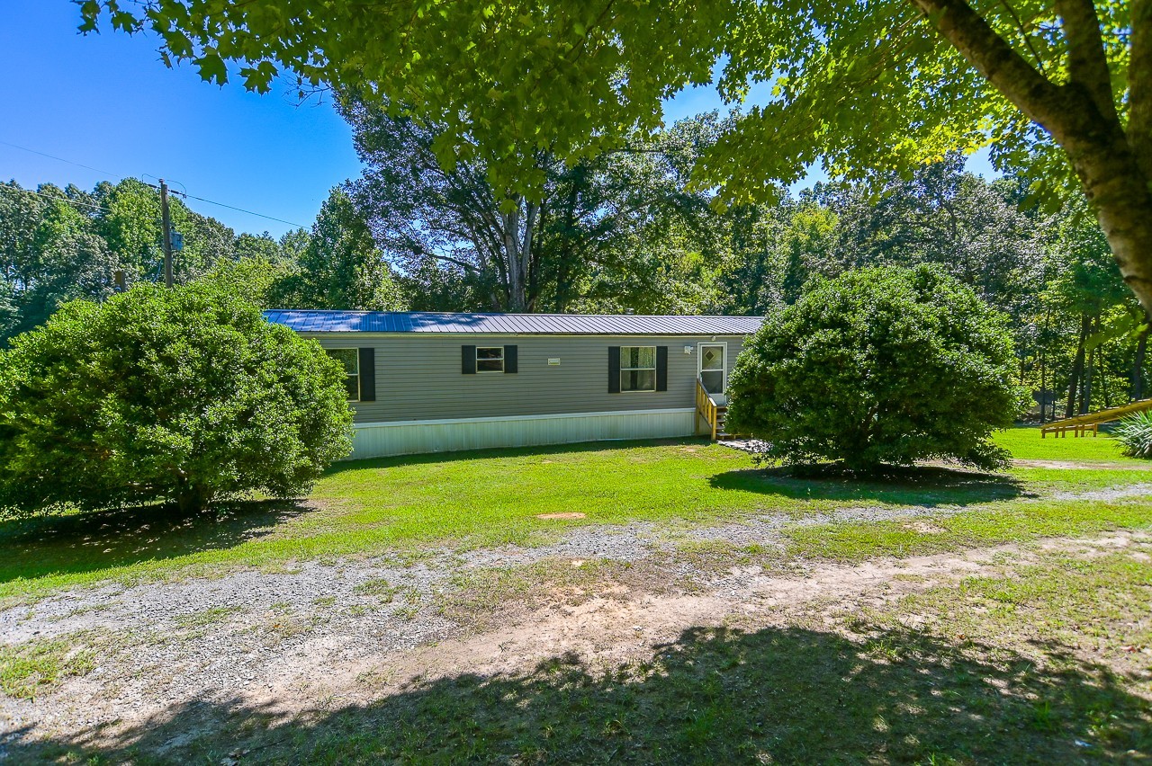 a front view of house with yard and trees