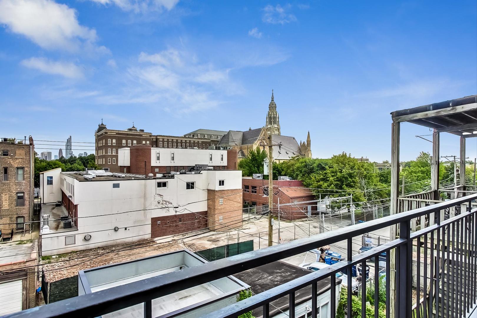 1033 South Racine Avenue, Unit 3SR Chicago, IL 60607 - Photo 18 of 49 a view of a city from a balcony with furniture