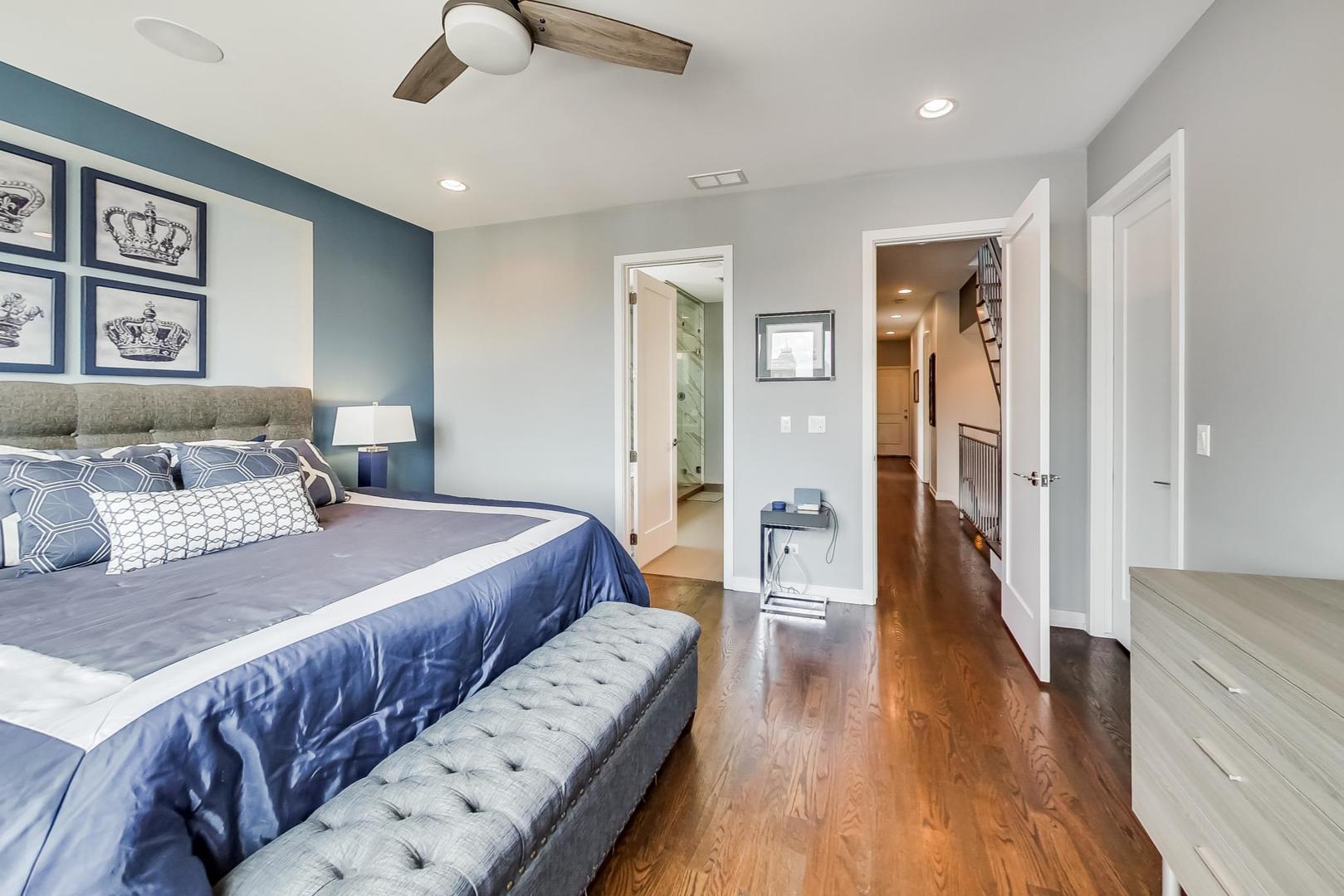 1033 South Racine Avenue, Unit 3SR Chicago, IL 60607 - Photo 25 of 49 a bedroom with a large bed and a chandelier