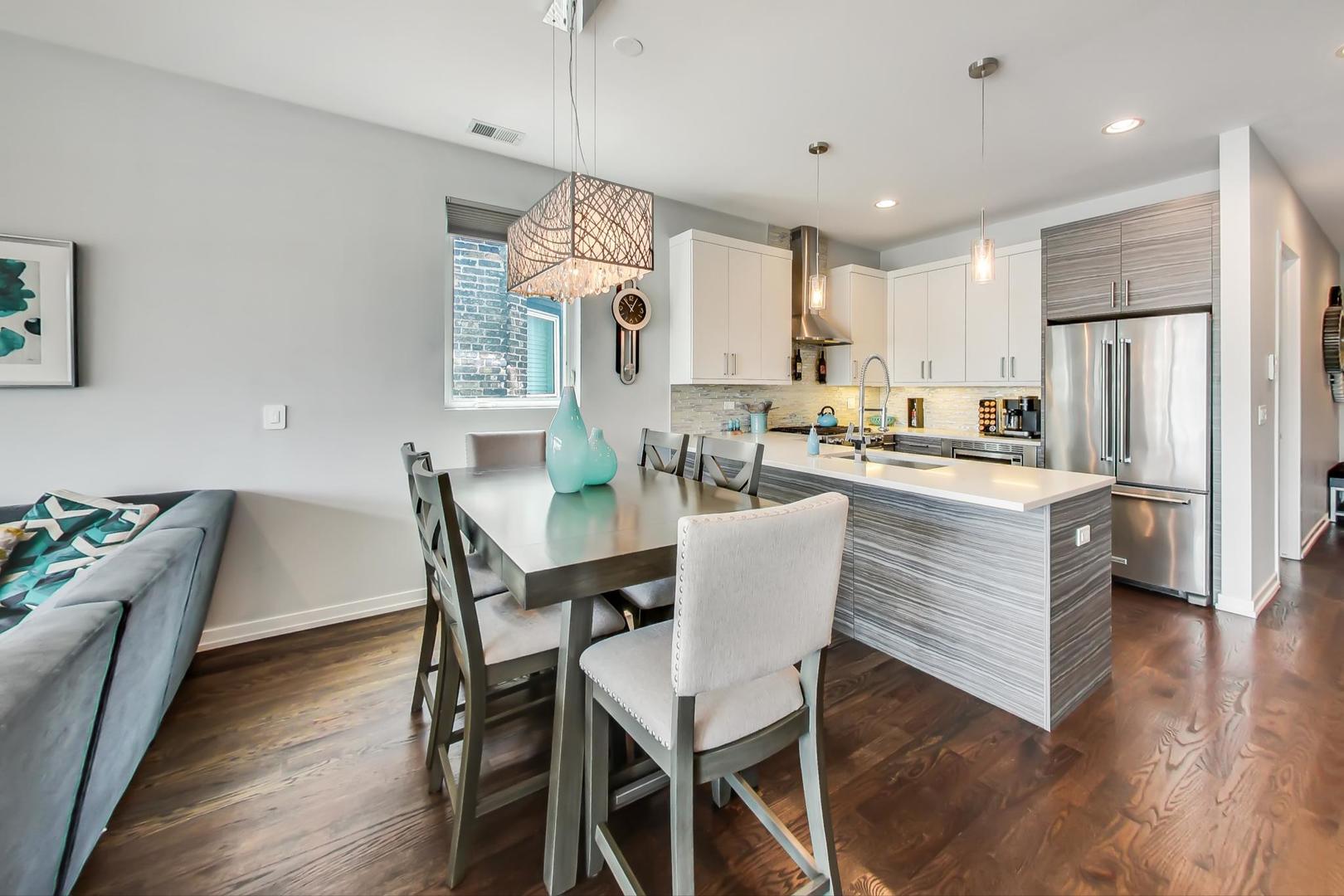 1033 South Racine Avenue, Unit 3SR Chicago, IL 60607 - Photo 9 of 49 a dining room with kitchen island stainless steel appliances furniture a dining table and chairs