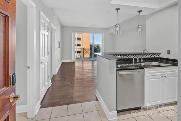a kitchen with white cabinets and appliances
