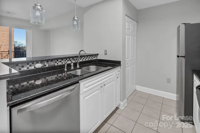 a kitchen with granite countertop a stove and a sink
