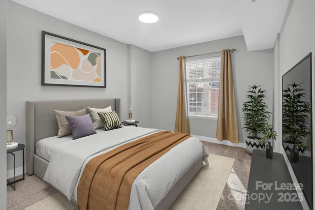 a bedroom with bed and glass window