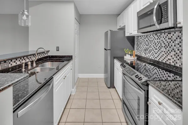 a kitchen with granite countertop cabinets and steel stainless steel appliances