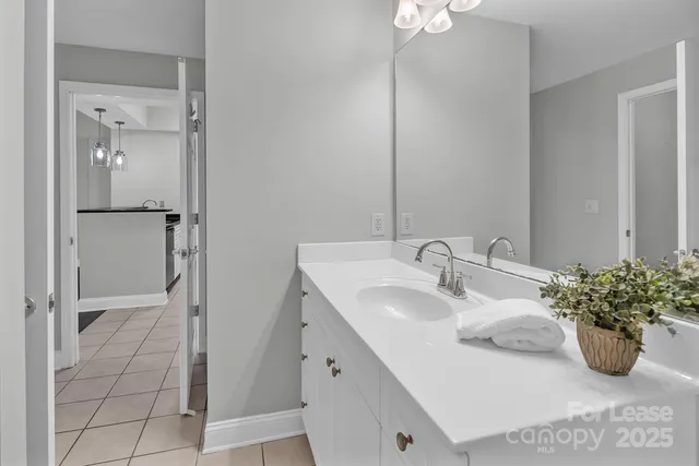 a bathroom with a sink a vanity and a mirror