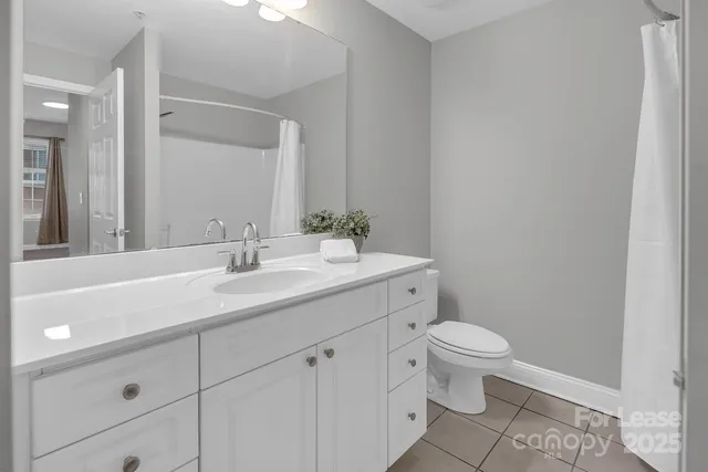 a bathroom with a sink a toilet a mirror and vanity