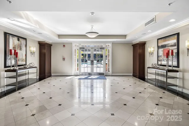 a living room with couches and kitchen view with wooden floor