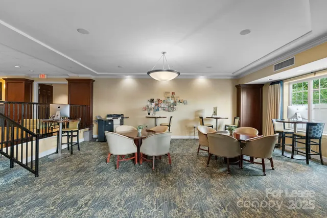 a living room with furniture a fireplace and a large window