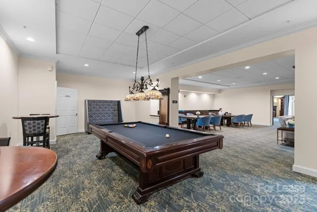 a living room with furniture a flat screen tv and a table