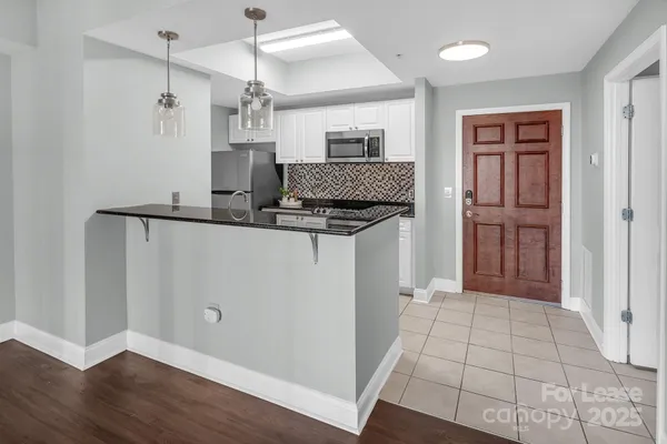 a kitchen with kitchen island a counter top space and stainless steel appliances