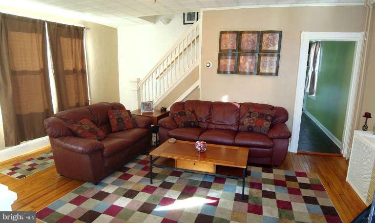 5504 Tramore Road Baltimore, MD 21214 - Photo 3 of 29 a living room with furniture and a rug