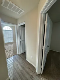 an empty room with wooden floor and a window