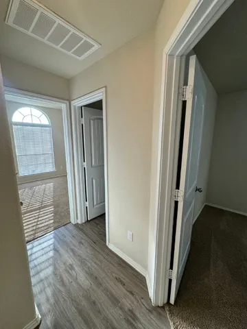 an empty room with wooden floor and a window