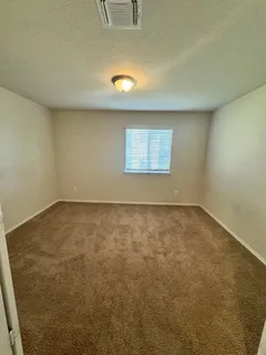 an empty room with a empty space and windows