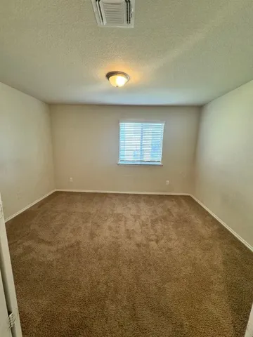 an empty room with a empty space and windows