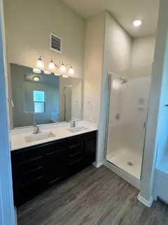 a bathroom with a double vanity sink and a mirror