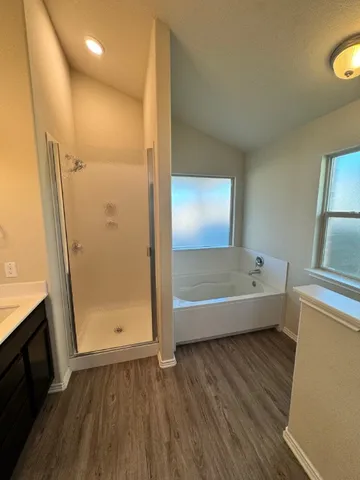 a bathroom with a bathtub and a view of bathroom