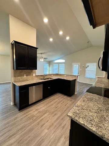 a kitchen with a sink and a microwave