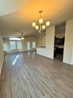 a view of a room with wooden floor
