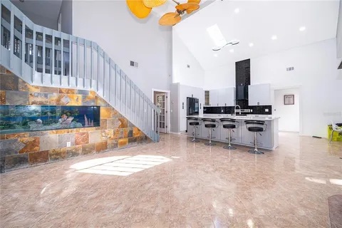 a view of kitchen with microwave a stove and a dining table chair