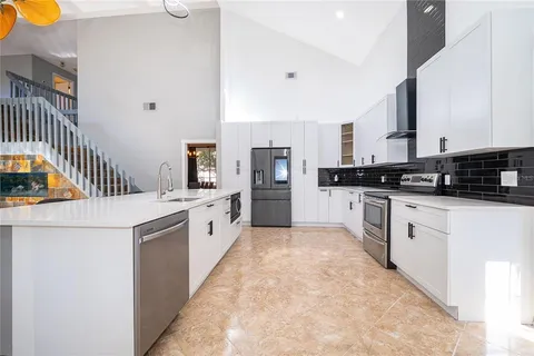 a kitchen with stainless steel appliances a refrigerator and a stove
