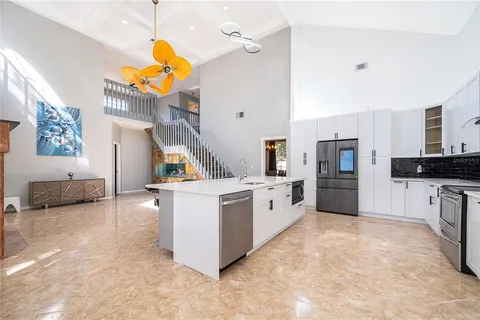 a kitchen with stainless steel appliances a stove a sink and a refrigerator
