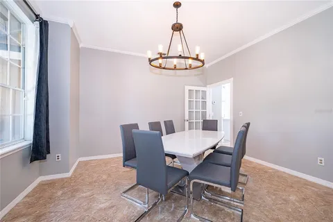 a view of a dining room with a table and chairs