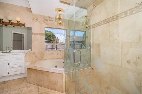 a bathroom with a tub sink and mirror