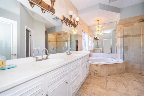 a spacious bathroom with a bathtub sink and mirror