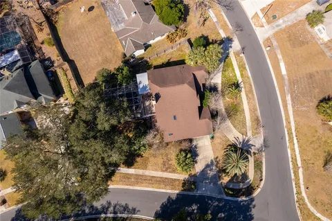 an aerial view of a house with a yard and a fountain