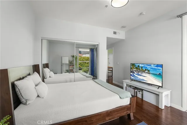 a bedroom with a bed and a flat screen tv