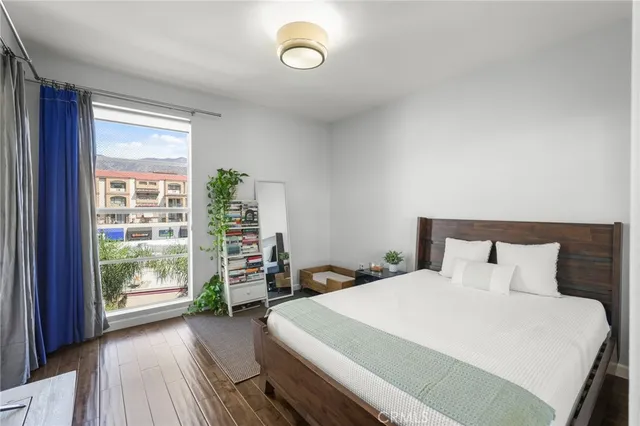 a bedroom with a bed and a potted plant
