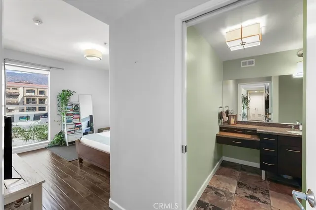 a bathroom with a granite countertop sink and a mirror