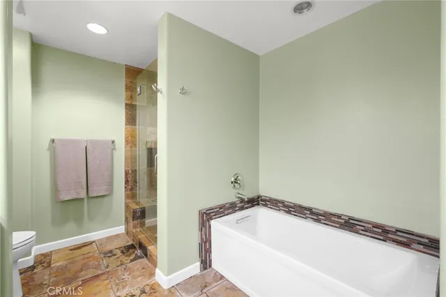 a bathroom with a glass shower door