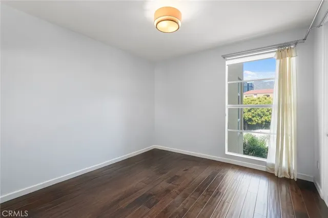 a view of room with wooden floor and fan