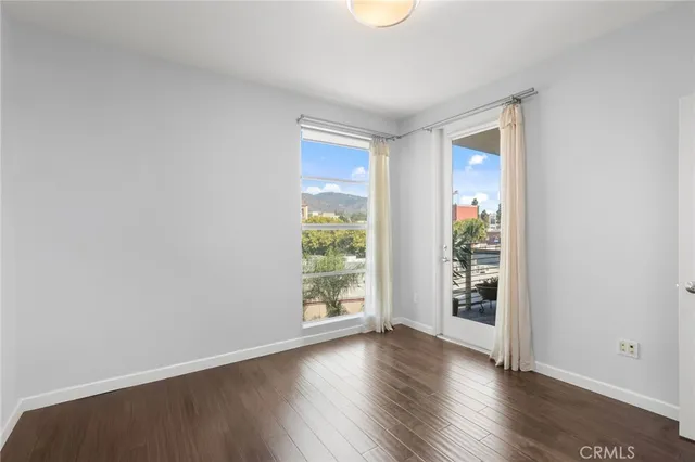 a view of room with wooden floor and fan