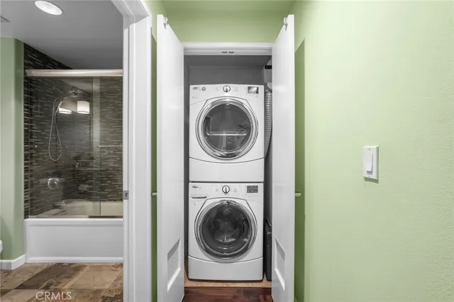 a view of a balcony with chairs and potted plants