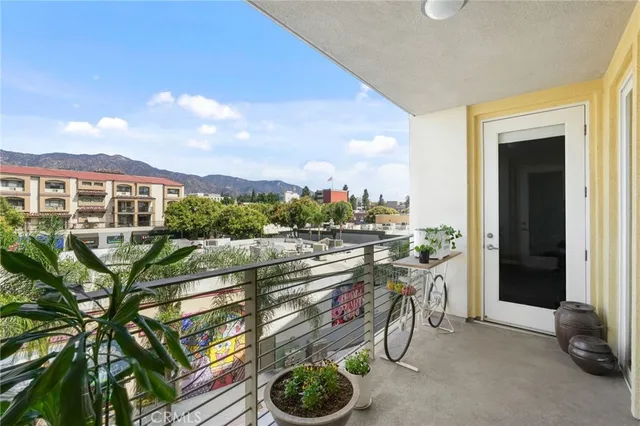 a view of a balcony with chairs and potted plants