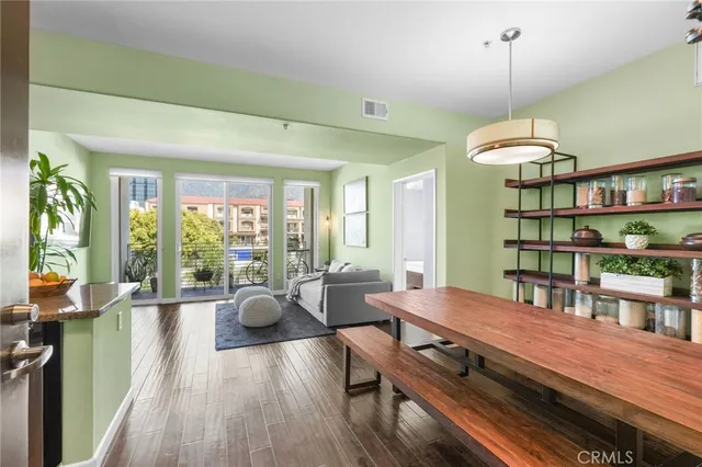 a living room with furniture a flat screen tv and a floor to ceiling window
